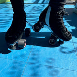 Ankle down shot of a woman wearing Sure-Grip roller skates with 150 Suede boot and Avanti Aluminum plate available exclusively at Seaside Skates
