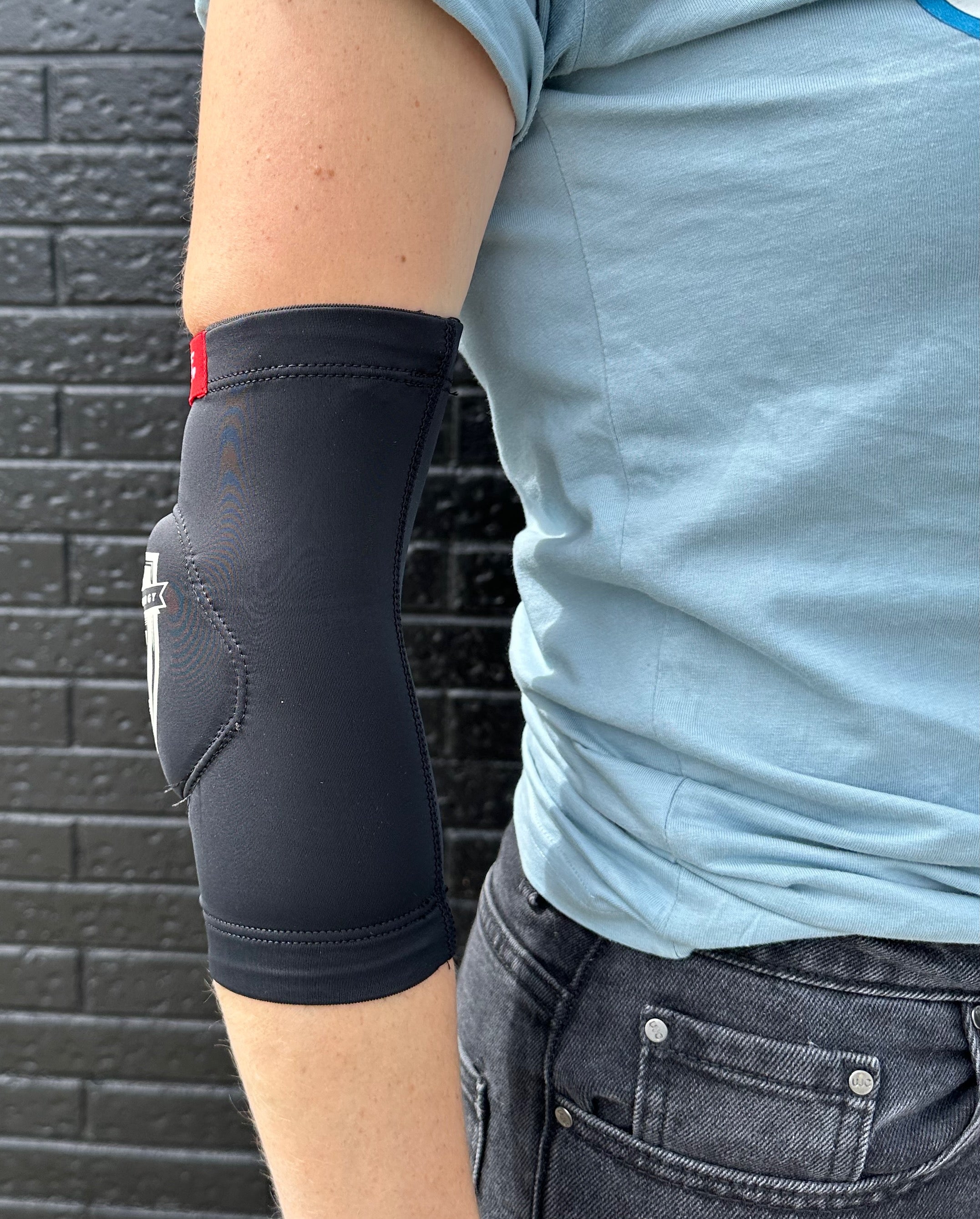 Side view of FP Low profile elbow pad fits under clothing