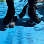 Ankle down shot of a woman wearing Sure-Grip roller skates with 150 Suede boot and Avanti Aluminum plate available exclusively at Seaside Skates