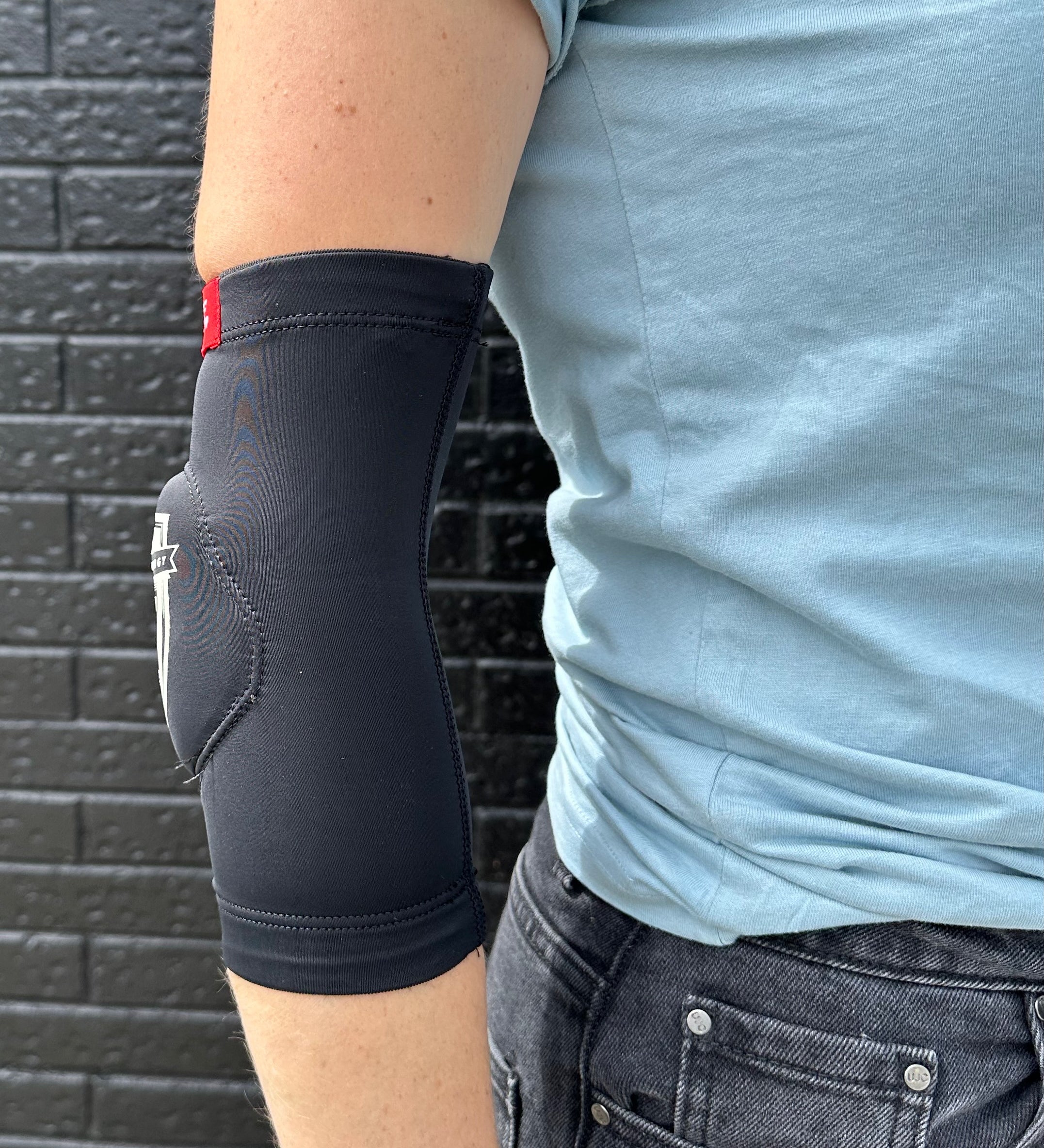 Side view of FP Low profile elbow pad fits under clothing