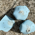 Three roller skate toe caps that have seen better days. They are heavily scuffed and worn through the material in places.
