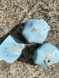 Three roller skate toe caps that have seen better days. They are heavily scuffed and worn through the material in places.