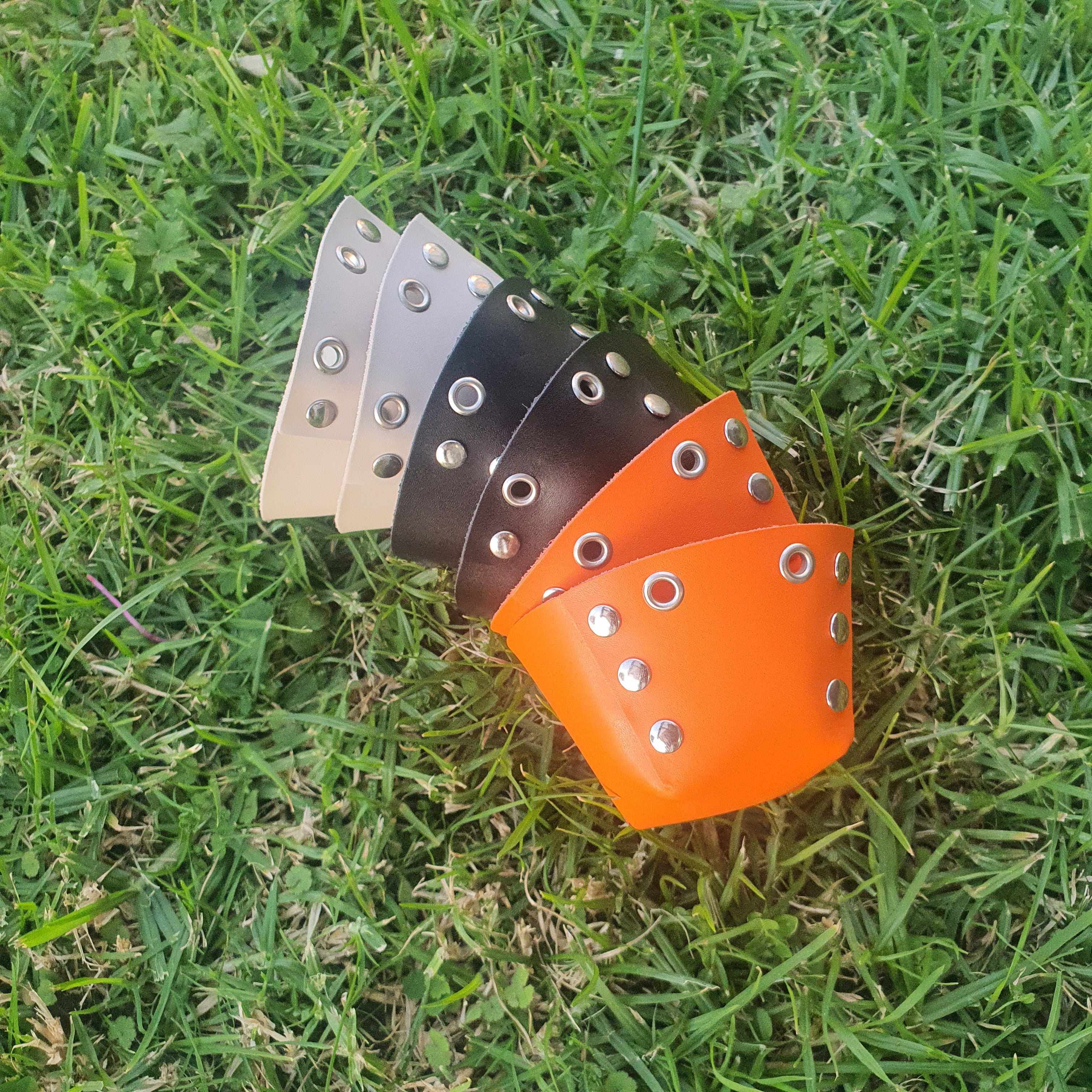 A set of colorful knee tap Roller Skate park toe caps with metallic studs 